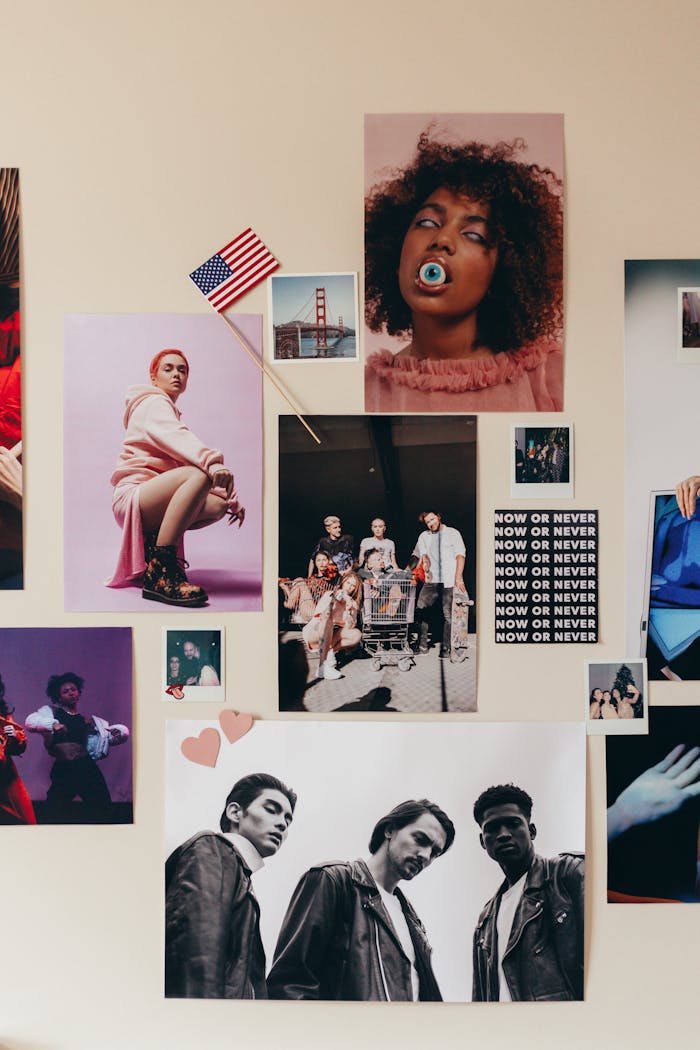A vibrant photo collage on a wall featuring diverse fashion and cultural posters with an American flag decoration.
